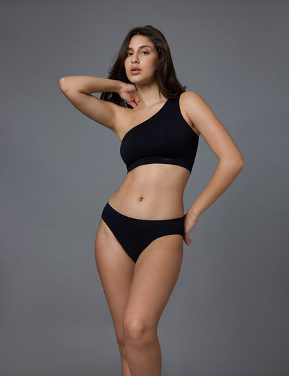 Woman wearing a black bikini against a gray background