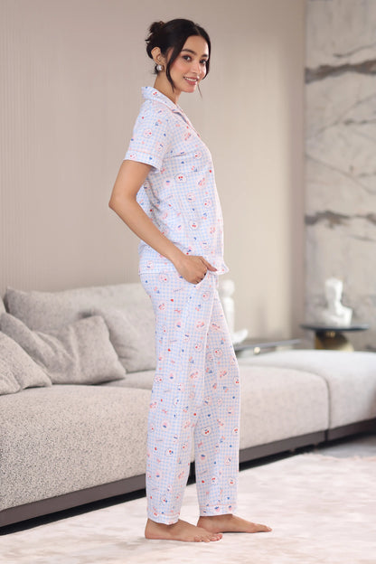 Woman wearing a patterned pajama set in a modern living room.