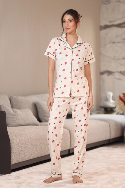 Woman wearing a pajama set with a heart pattern in a living room.