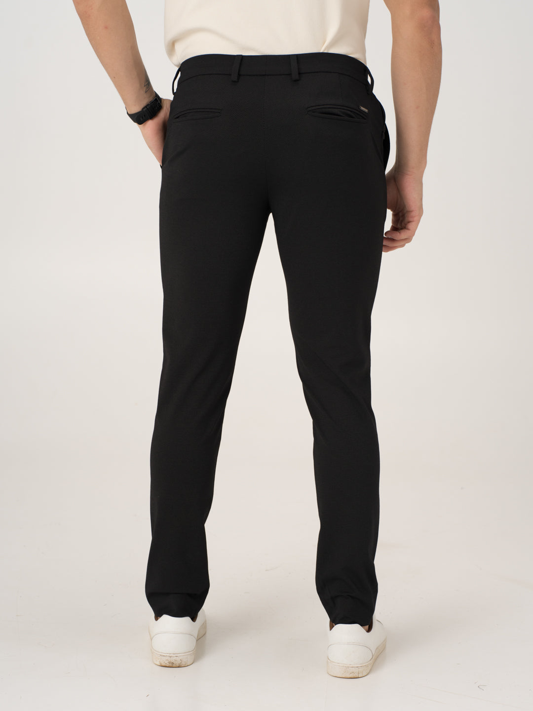 Rear view of black stretchable trousers by pant project, focusing on the waistband and back pockets
