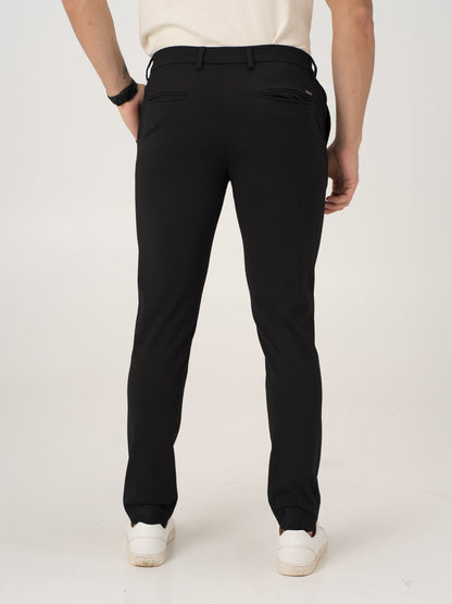 Rear view of black stretchable trousers by pant project, focusing on the waistband and back pockets