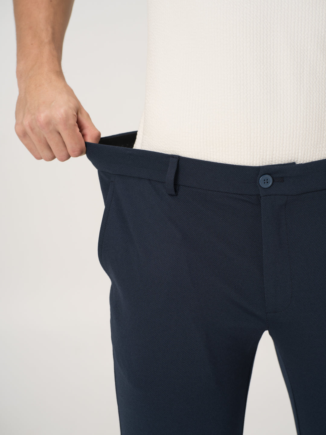 Close-up view of navy blue stretchable trousers by pant project, focusing on the stretchable waistband