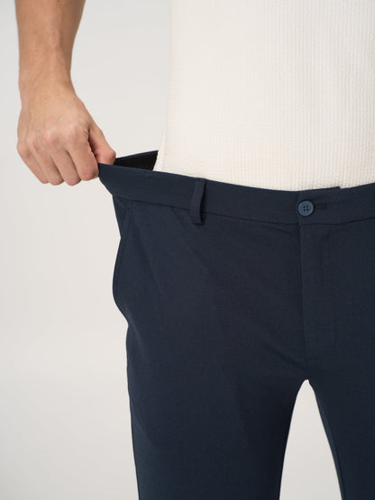 Close-up view of navy blue stretchable trousers by pant project, focusing on the stretchable waistband