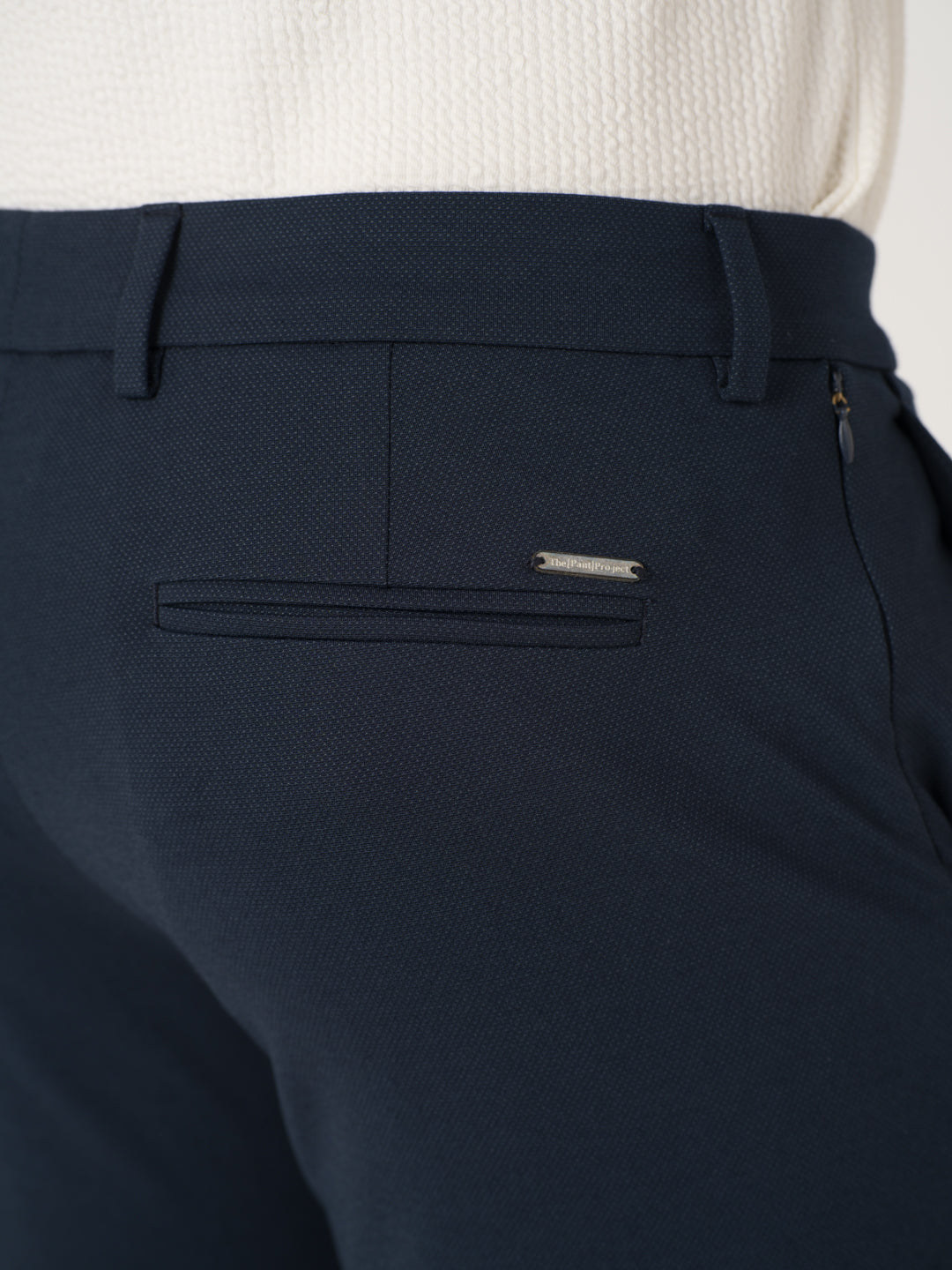 Close-up view of navy blue stretchable trousers by pant project, focusing on the waistband and pocket detail