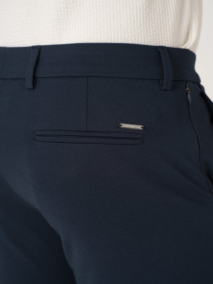 Close-up view of navy blue stretchable trousers by pant project, focusing on the waistband and pocket detail