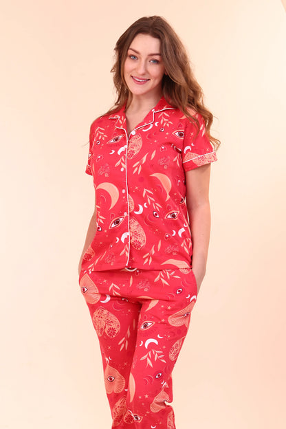Woman posing in Red Lovespell Print Pyjama Set, breathable 100% cotton loungewear and nightsuit for summer by NapStory.