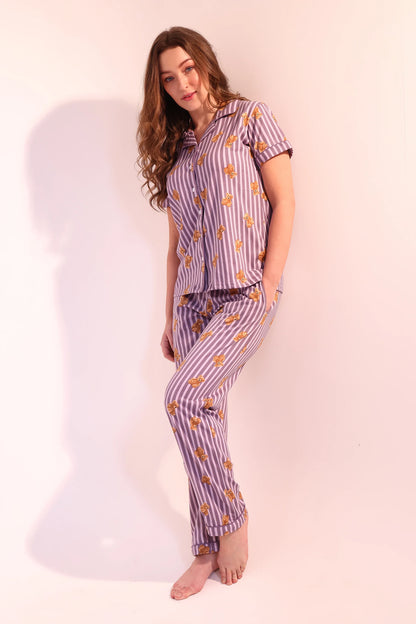 Playful pose of woman in comfortable Teddyboo print cotton Pyjama Set by NapStory.